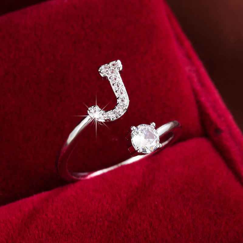 Fashionable 26 English Letters Four-Prong Synthetic Synthetic Zirconia Open Adjustment Ring Ｊ Silvery